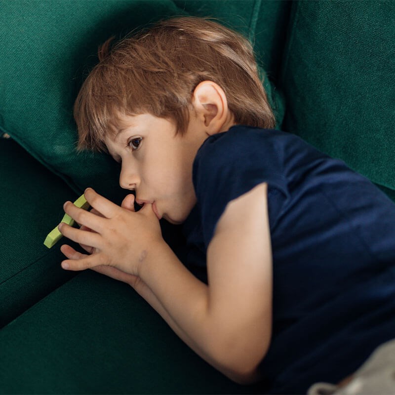 Child on the couch sucking thumb